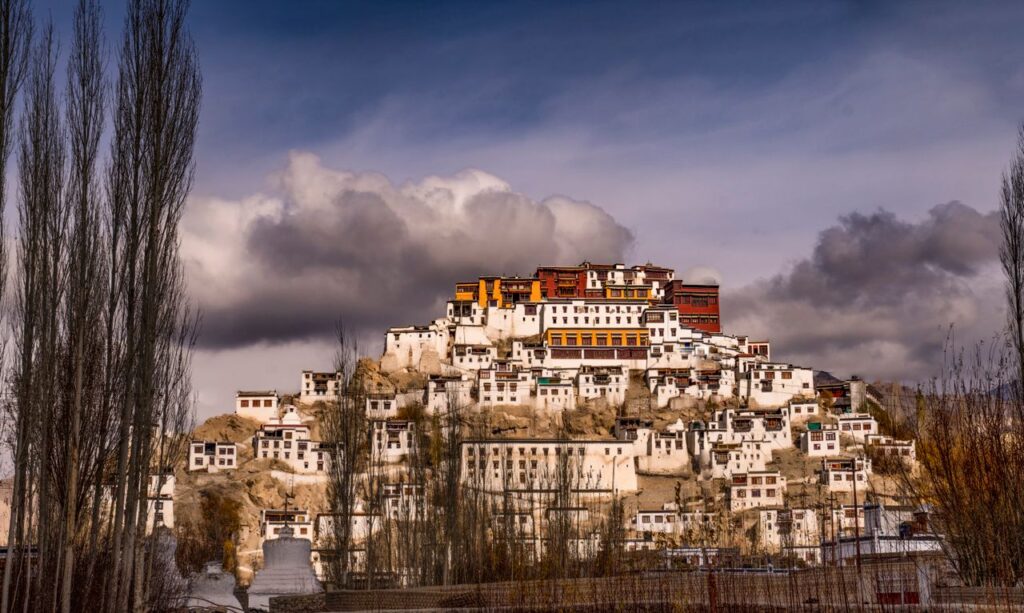 Delhi to Leh Ladakh tour packages mountain road journey India Leh Ladakh Pangong Lake blue water scenic view Khardung La pass highest motorable road Ladakh trip Nubra Valley sand dunes Bactrian camel safari Ladakh Leh Ladakh bike trip adventure Himalayan mountains Delhi to Ladakh family tour package FlixHoly travel Ladakh honeymoon couple scenic lake mountains trip Shanti Stupa Leh sunset panoramic view Ladakh tourism Magnetic Hill Ladakh natural gravity illusion road FlixHoly Leh Ladakh holiday package booking India